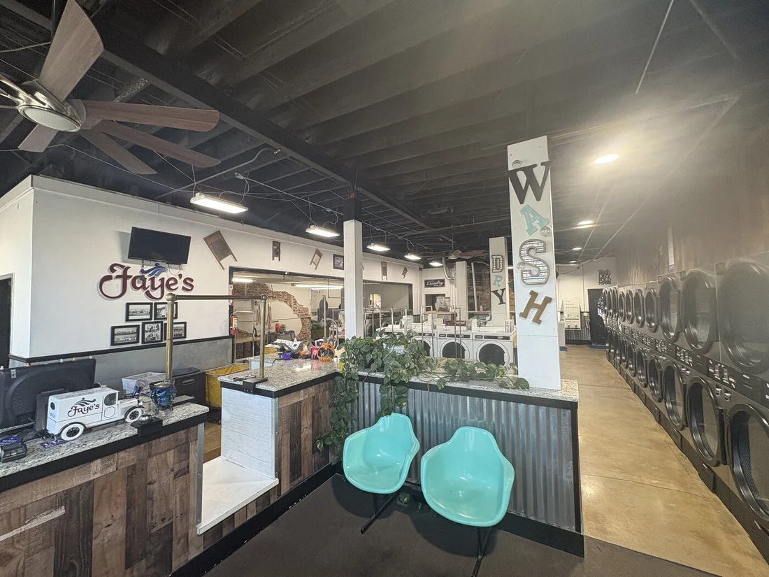 Faye's laundry interior with equipment and seating