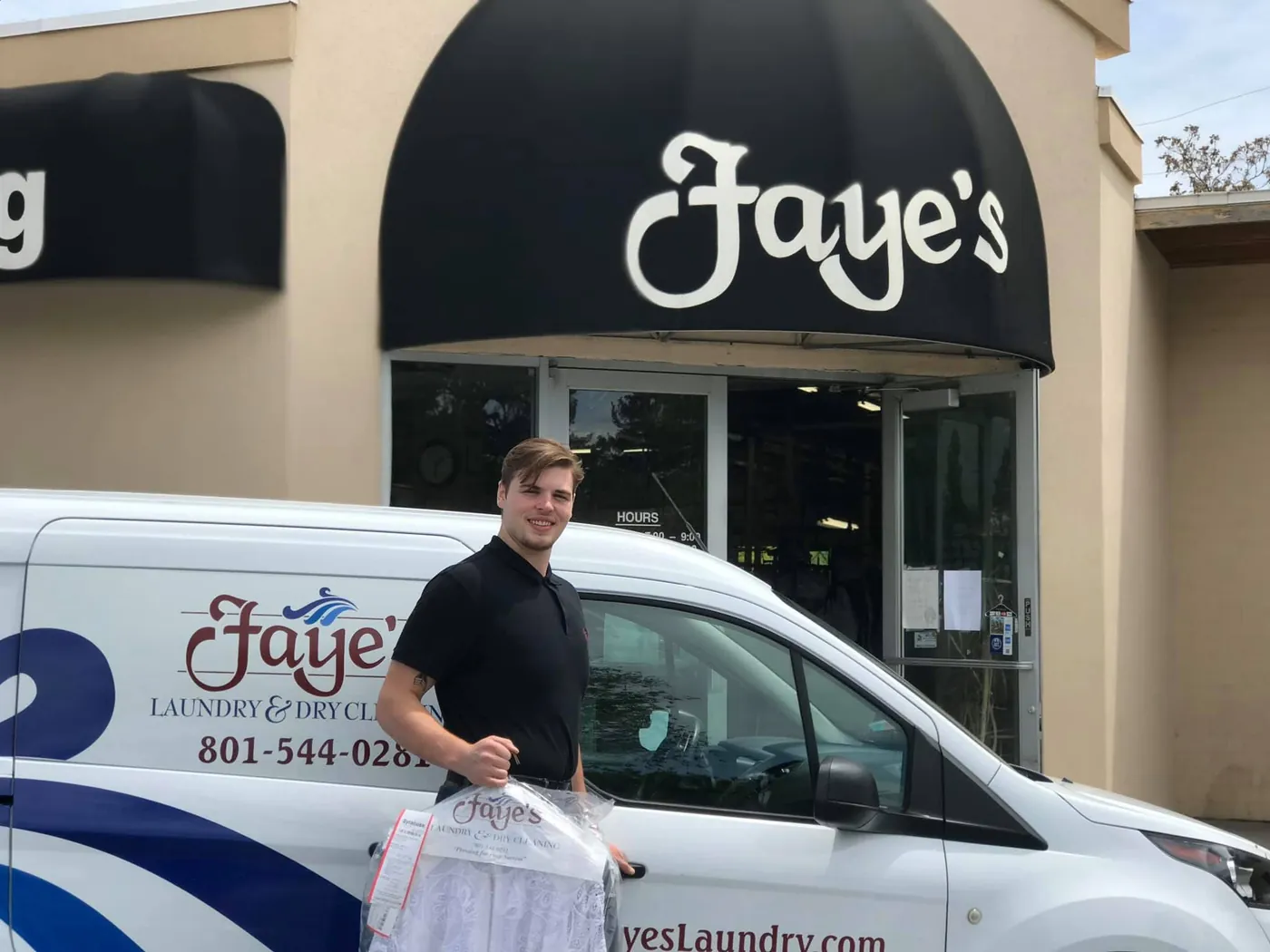 A Faye's driver standing with completed garments beside a branded Faye's delivery van outside the store